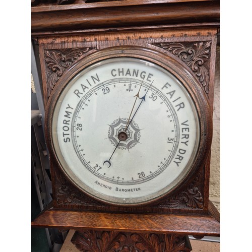 105 - Victorian solid oak banjo wall barometer carved with foliate details, with porcelain dial, brass bez... 