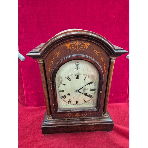 108 - Edwardian mahogany cased mantel clock with domed top, turned columns and scrolling boxwood inlay. En... 