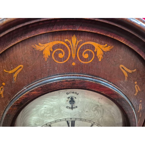 108 - Edwardian mahogany cased mantel clock with domed top, turned columns and scrolling boxwood inlay. En... 