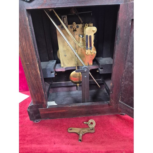 108 - Edwardian mahogany cased mantel clock with domed top, turned columns and scrolling boxwood inlay. En... 