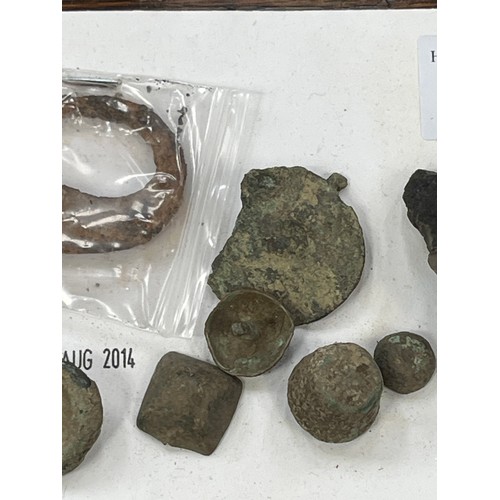 36 - A small collection of metal detector finds, including a hook, buttons, studs, knapped flint etc.