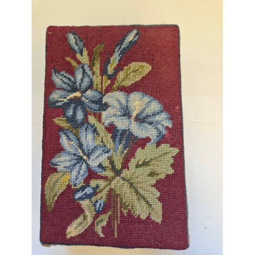 39 - A small wooden box with a needlepoint lid, embroidered with blue Lillies on a red ground.