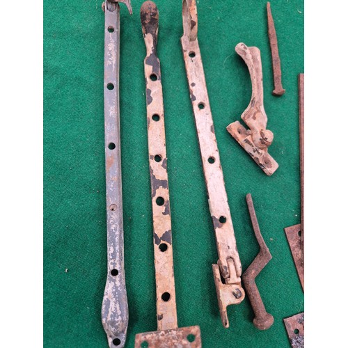 221 - Lot of wrought and cast iron hardware, including door latches, sash window stays, hooks etc.