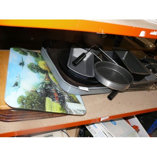 313 - Shelf of oven dishes and chopping boards to include 1 with a train