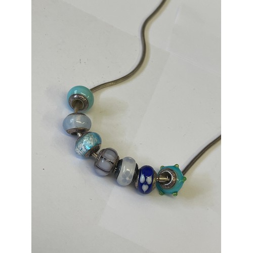 33 - A SOLID SILVER LOVE LINK NECKLACE WITH 7 CHARMS ALSO SILVER WEIGHT 31.01GR