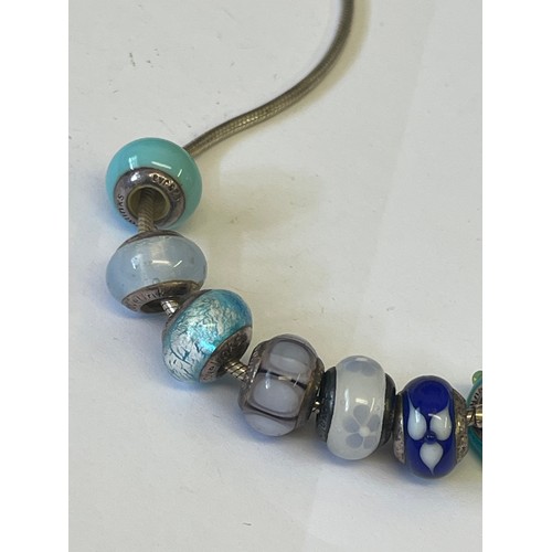 33 - A SOLID SILVER LOVE LINK NECKLACE WITH 7 CHARMS ALSO SILVER WEIGHT 31.01GR