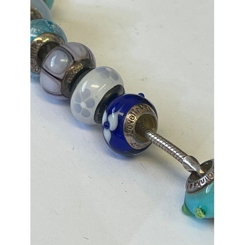 33 - A SOLID SILVER LOVE LINK NECKLACE WITH 7 CHARMS ALSO SILVER WEIGHT 31.01GR