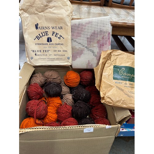359 - Large box of vintage balls of wool in autumnal russet colours together with a stencilled rug canvas