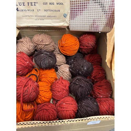359 - Large box of vintage balls of wool in autumnal russet colours together with a stencilled rug canvas