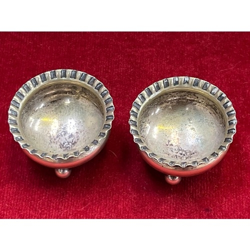 8 - Pair of silver plated open table salts, with scalloped rims and three little ball feet. Marked benea... 