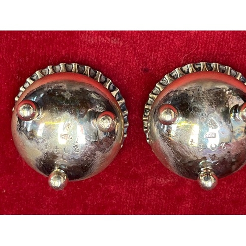 8 - Pair of silver plated open table salts, with scalloped rims and three little ball feet. Marked benea... 