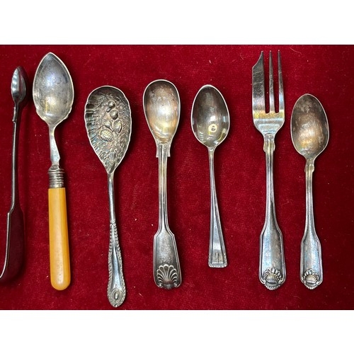 12 - Collection of silver plated flatware, including a berry spoon, sugar nip tongs, teaspoons etc.