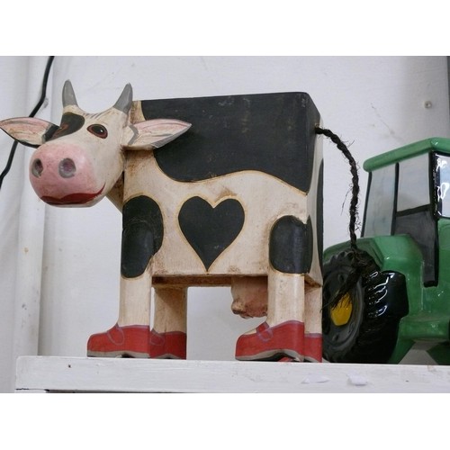 49 - CERAMIC TRACTOR MONEY BOX (JOHN DEERE) AND A CARVED WOODEN COW MONEY BOX.