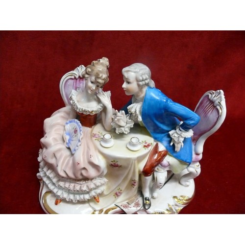 52 - ARTMARK PORCELAIN STATUE OF A EUROPEAN COUPLE HAVING TEA AT TABLE.