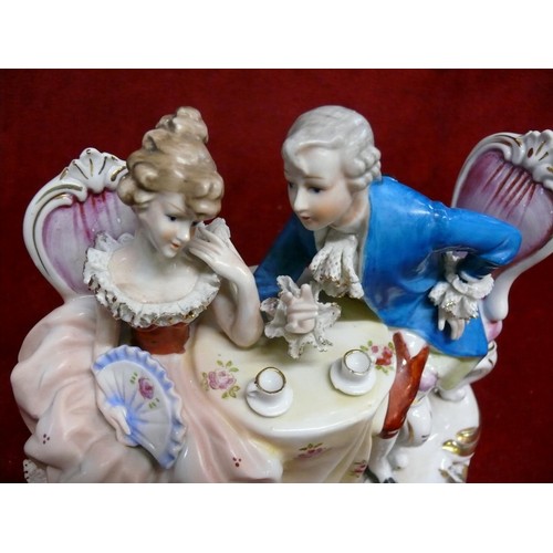 52 - ARTMARK PORCELAIN STATUE OF A EUROPEAN COUPLE HAVING TEA AT TABLE.