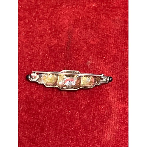 22 - An Art Deco style silver and marcasite brooch with central diamante and French jet cabochon tips