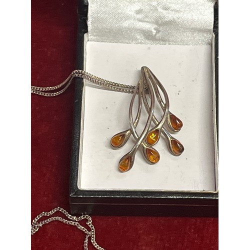 23 - An Art Nouveau style silver (untested) and amber frond pendant on a 925 silver chain