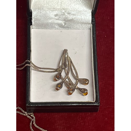 23 - An Art Nouveau style silver (untested) and amber frond pendant on a 925 silver chain