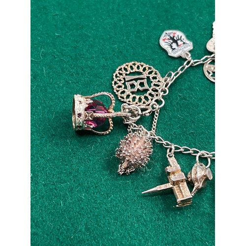 49 - Vintage silver charm bracelet with 14 charms - various marks inc 