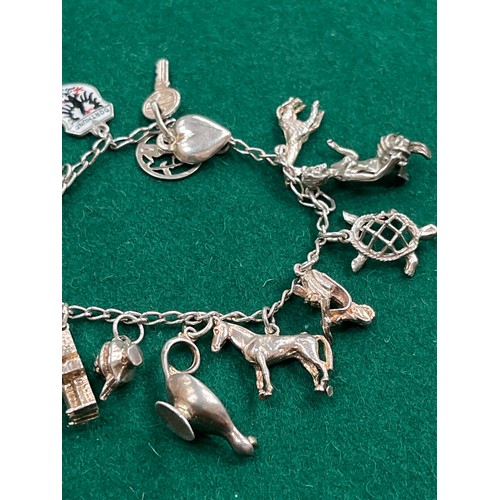 49 - Vintage silver charm bracelet with 14 charms - various marks inc 
