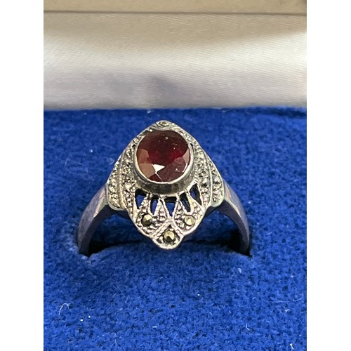 40 - An Art Deco silver ring set with an oval cut garnet & marcasite - size O/P