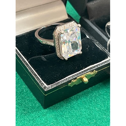 44 - Two sterling silver rings with large square cut pale blue crystal stones - size R together with a 92... 