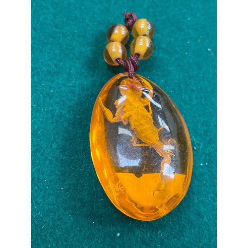 41 - A large amber oval pendant with insect inclusion - 5cm