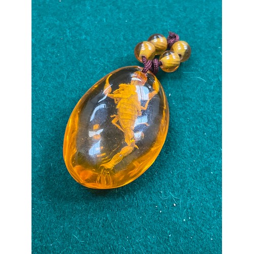 41 - A large amber oval pendant with insect inclusion - 5cm