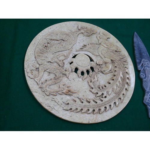 57 - A large Chinese stone disc (26cm dia) depicting a dragon and a phoenix - in Chinese culture depicts ... 