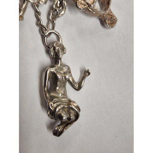 49 - Vintage silver charm bracelet with 14 charms - various marks inc 