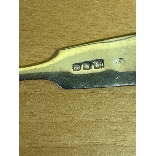 17 - A Sterling silver tea spoon with rifle club insignia, hallmarked London 1932, 16 grams, together wit... 