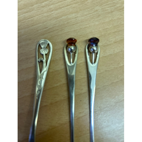 17 - A Sterling silver tea spoon with rifle club insignia, hallmarked London 1932, 16 grams, together wit... 