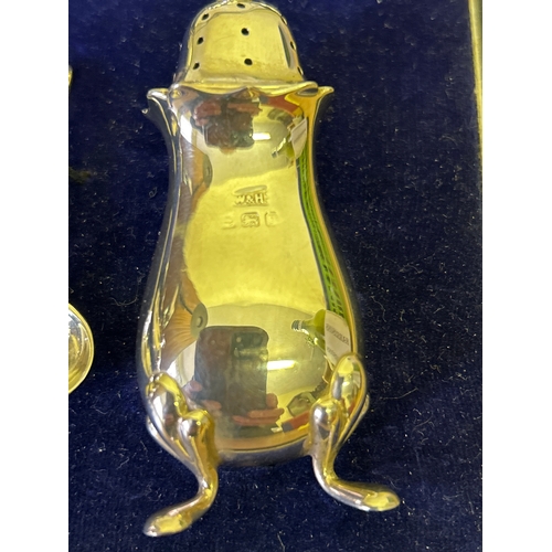 23 - A very good Sterling silver cased condiment set by  Walker & Hall, comprising 2 mustard pots with bl... 