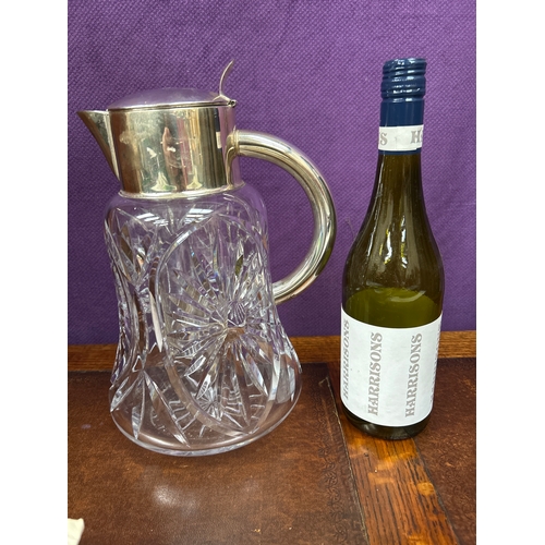 29 - A large & heavy West German cut glass & silver plated wine jug with glass liner for ice. The thumb p... 