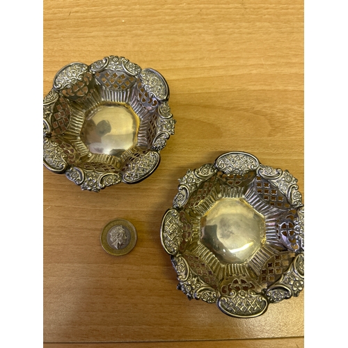 33 - A very pretty pair of small Victorian silver basket dishes with pierced sides and ornate floral & tr... 