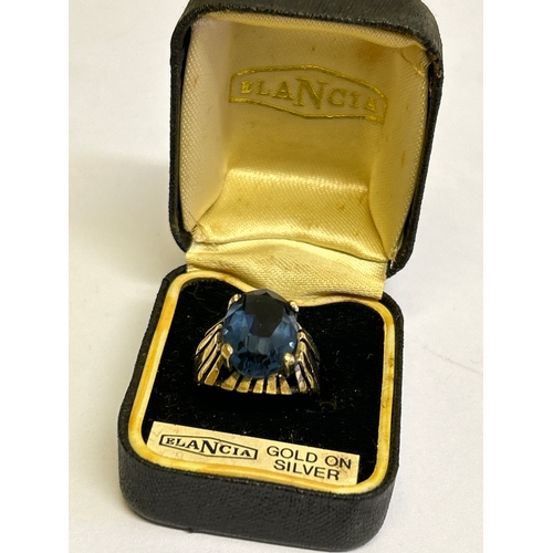 43 - A vintage circa 1970’s gold on silver ring set with an oval cut blue stone. Marked SILVER (rubbed)  ... 