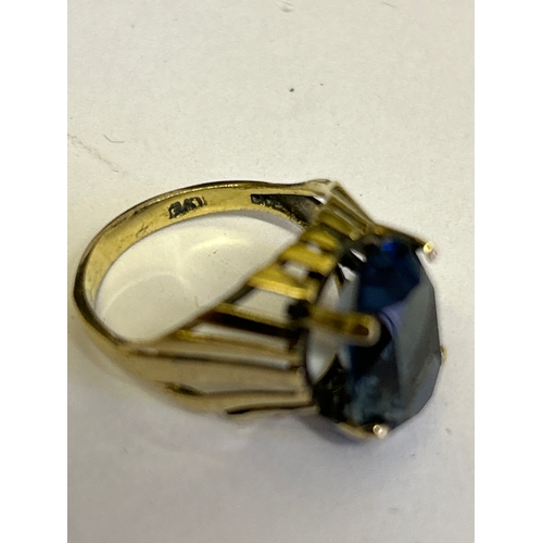 43 - A vintage circa 1970’s gold on silver ring set with an oval cut blue stone. Marked SILVER (rubbed)  ... 
