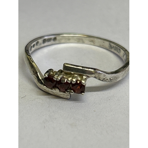 44 - Two vintage sterling silver rings, one in crossover style with 3 garnet stones hallmarked Sheffield ... 