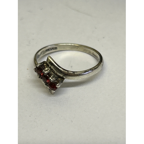 45 - 3 Sterling silver vintage rings, including a flush mounted ring with garnet (size L) a crossover rin... 