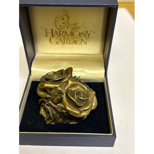 39 - A very heavy Sterling Silver lidded pot in the form of roses, the inside with a miniature group of f... 