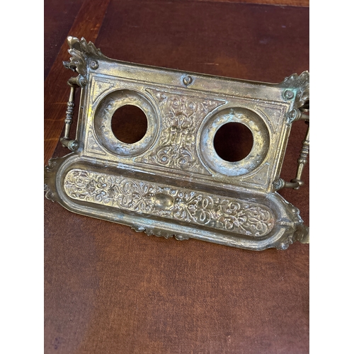 326 - An early 20th Century solid brass desk stand, with raised gallery back. The inkwells with amber glas... 