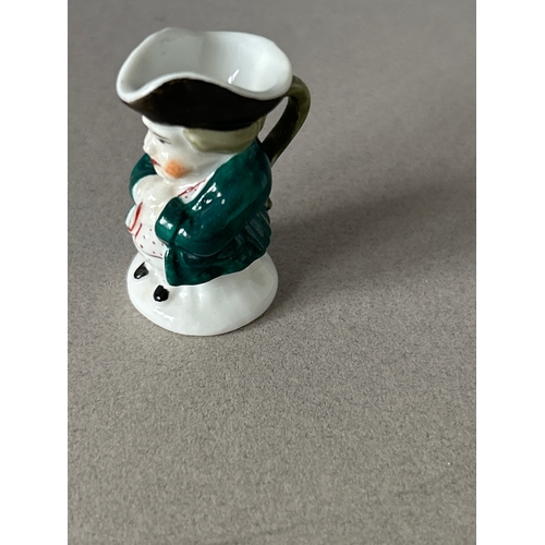 171 - Derby and Royal Crown Derby four pieces to include:- blanc de chine figurine of a child with a lyre,... 