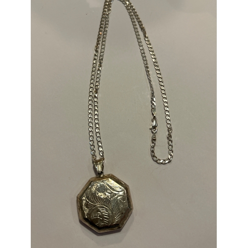 94 - A sterling silver chain with sterling silver locket engraved with a scrolling leaf pattern