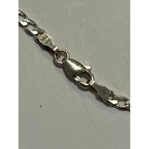 94 - A sterling silver chain with sterling silver locket engraved with a scrolling leaf pattern