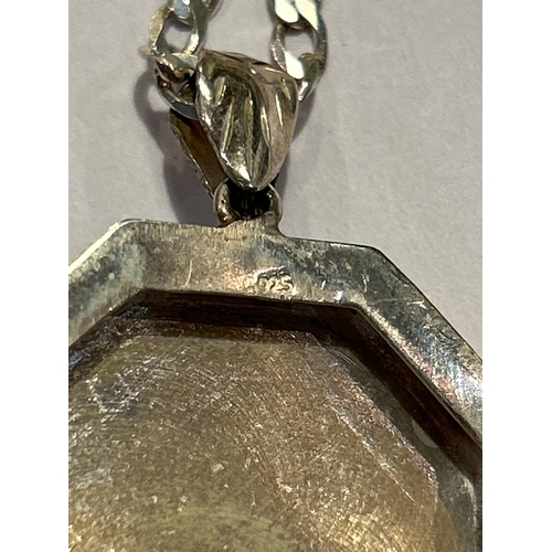 94 - A sterling silver chain with sterling silver locket engraved with a scrolling leaf pattern