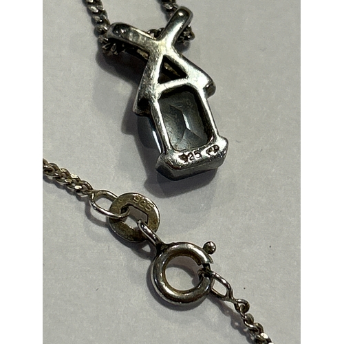 95 - A sterling silver cross style pendant on chain, set with a square cut aquamarine stone. Both pendant... 