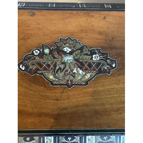 312A - A mid 19th Century ladies walnut work box with a marquetry panel to the lid depicting a basket of fl... 