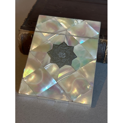 13 - A 19th Century card case covered with mother of pearl and with a silver star panel with engraved mon... 