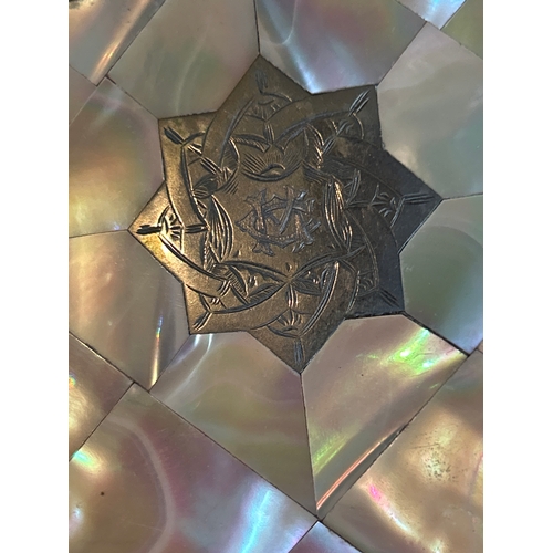 13 - A 19th Century card case covered with mother of pearl and with a silver star panel with engraved mon... 