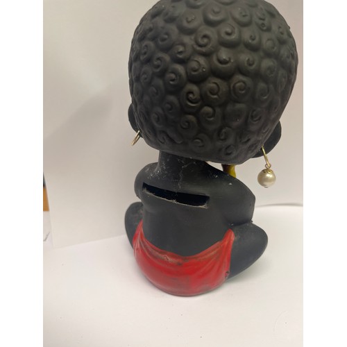 16 - A VINTAGE BLACK NODDING HEAD DOLL MONEY BOX HOLDING FRUIT